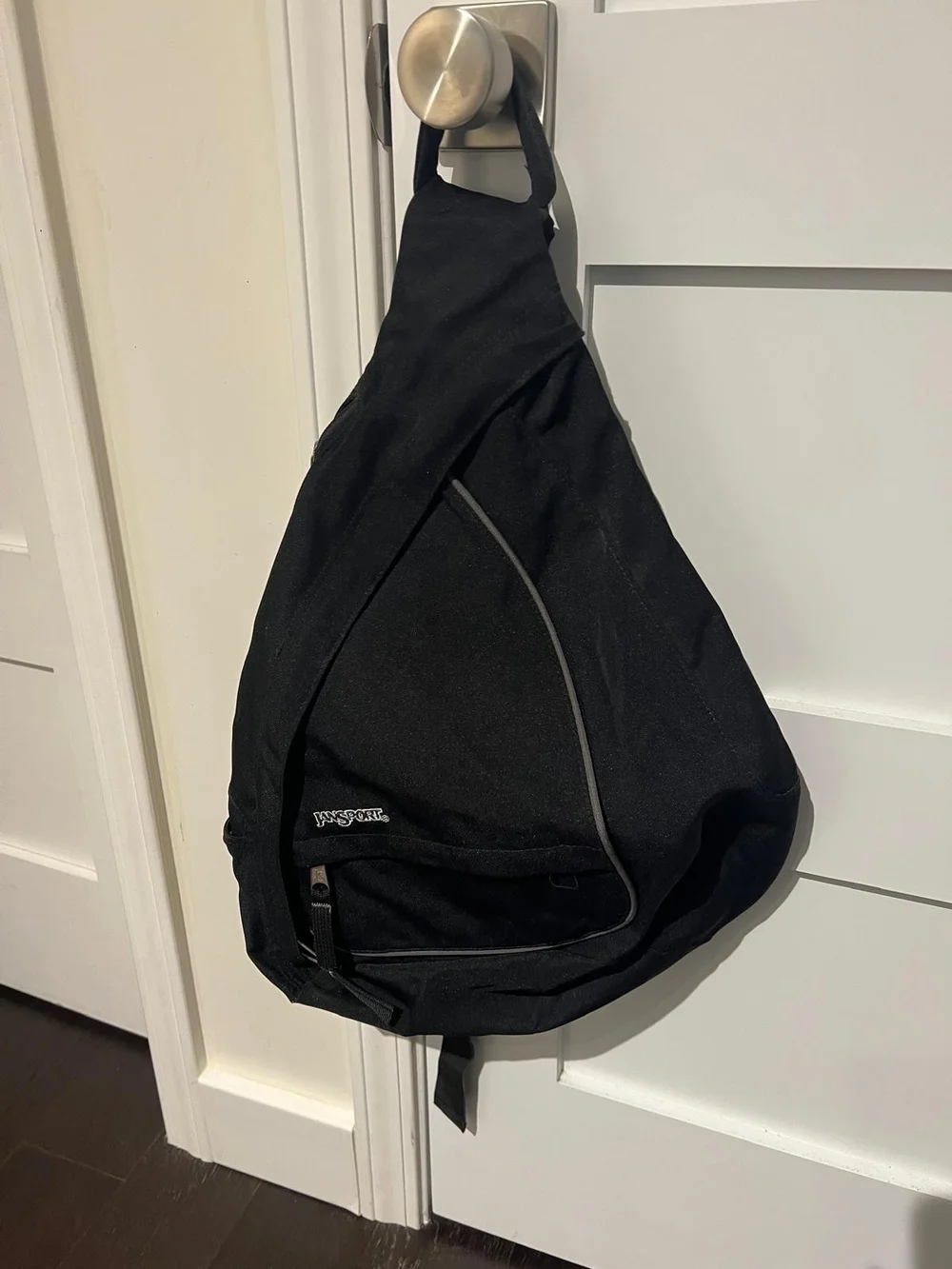 Jansport Black Sling Backpack with Front Zip Pocket